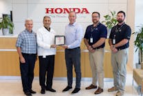 Ryan McCartney (third from the left), vice president and COO, Hillsboro Aviation, receives the Authorized Service Center plaque from Amod Kelkar (second from the left), head of the commercial business unit and vice president, customer service for Honda Aircraft Company.